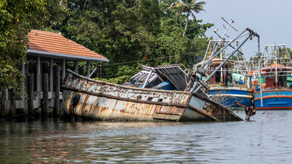 Sunken fishing trawler in the backwaters of Kerala, India