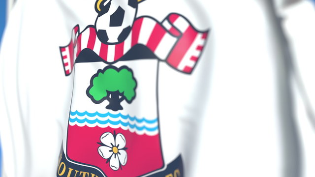 Waving flag with Southampton FC football club logo, close-up. Editorial 3D rendering