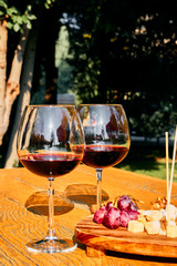 Glasses Of Fine Red Wine With Grape and cheese