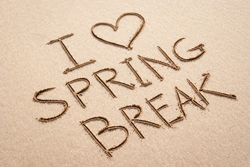 I Love Spring Break message handwritten on the beach with a heart drawn in smooth sand