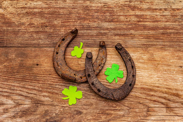 Two cast iron metal horse horseshoes, felt clove leaves. Good luck symbol, St.Patrick's Day concept