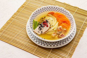 Korean noodle soup with smoked chicken and vegetables. Spicy dish for healthy meal