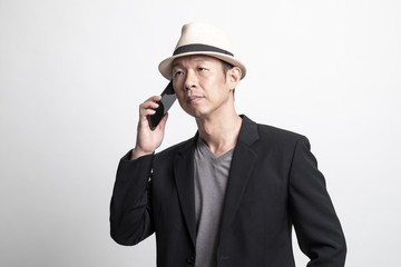 Adult Asian man talking with mobile phone.