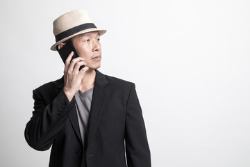 Adult Asian man  talking with mobile phone.