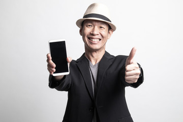 Adult Asian man show thumb up  with mobile phone.