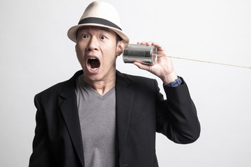 Surprised Adult Asian man  with tin can phone.