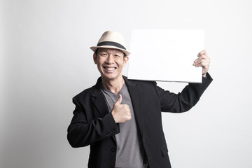 Adult Asian man show thumbs up with  white blank sign.