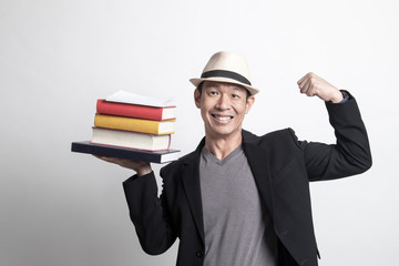 Adult Asian man studying  with may books.