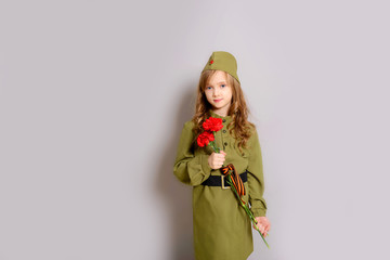 9 MAY. Beautiful little blonde girl kid with red carnation flowers for veterans. Victory Day. Memorial day. We remember! We are proud!