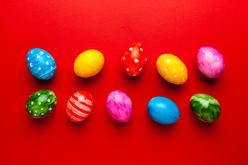 Bright easter eggs on red background. Retro colorful spring decoration.