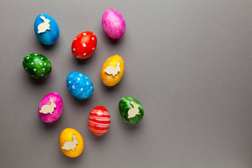 Bright easter eggs with bunny (rabbit) on grey background. Retro colorful spring decoration.