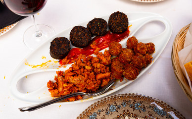 Spanish snack of blood sausage with chorizo, picadillo and roasted pepper