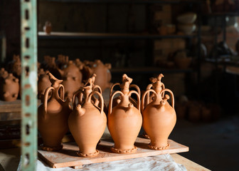 Handmade clay jugs in pottery workshop