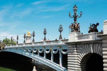 Alexander III golden bridge, symbol of Paris, in a beautiful summer day with blue sky