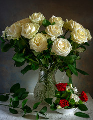 Beautiful bouquet of roses in a crystal jug. Still life. Vintage.