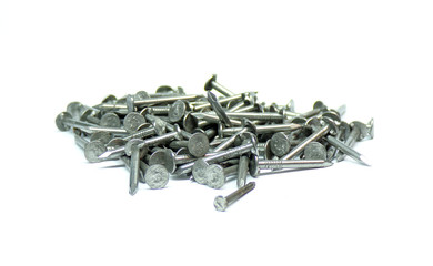 Nails. A pile of metal nails is isolated on a white background. Nails template for design. Small nails isolated on a white background close-up. The concept of construction and repair . Lots of screws.