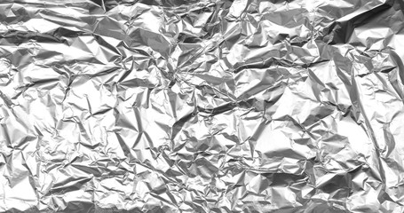 Crumpled silver foil texture. Abstract shiny background