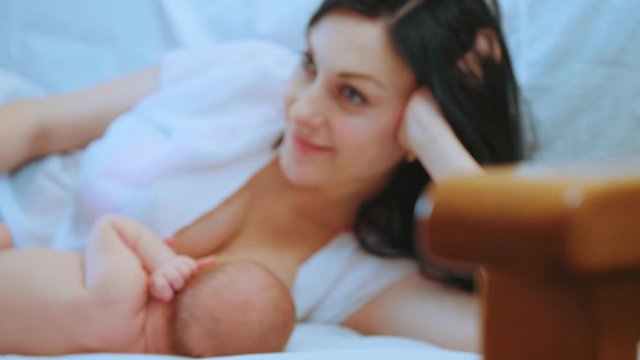 Young beautiful mother, breastfeeding her newborn baby boy. Mom breastfeeding infant. Concept breast feeding