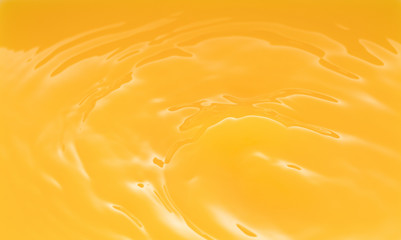 a swirling wave on the surface of orange juice.