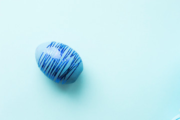 Blue easter eggs with striped sparkles on a blue background. Monochrome pattern.