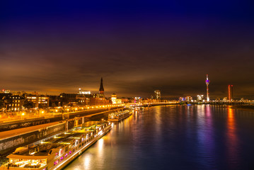 Night view of Dusseldorf on the bank of Rhine in Germany; peaceful lake and bright buildings