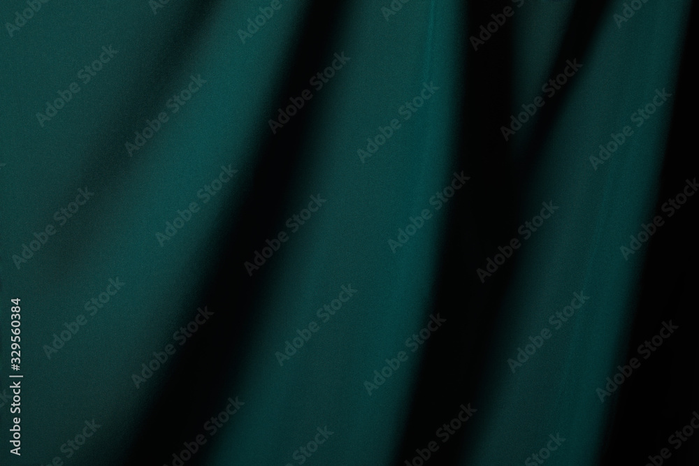 Wall mural close up view of emerald soft and wavy silk fabric