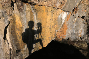 Fototapeta na wymiar The shadow of the photographer on the limestone cave wall