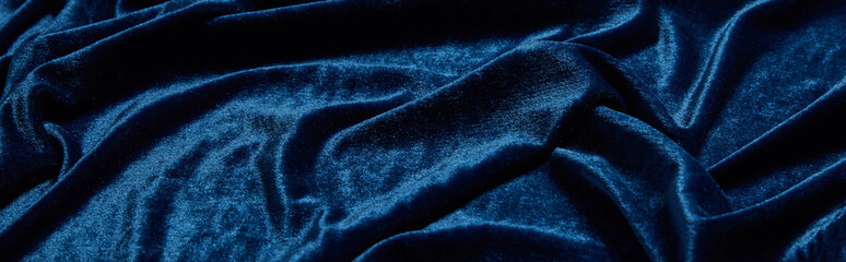 close up view of blue soft and crumpled velour textured cloth, panoramic shot