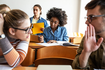 Group of university students taking a test in a classroom.Educational concept.	