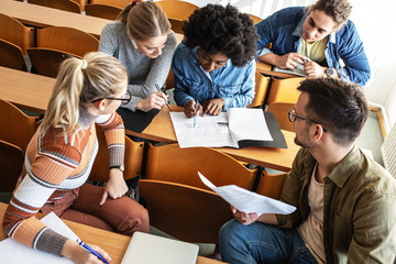 Group of university students taking a test in a classroom.Educational concept.	