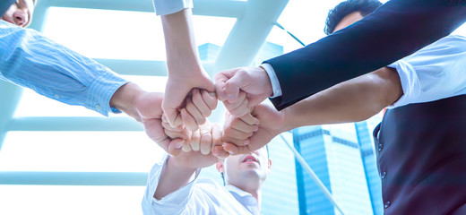 Diverse business people group put hands together in stack pile at training as concept of sales team corporate unity connection, teambuilding loyalty, support in teamwork, coaching, close up under view