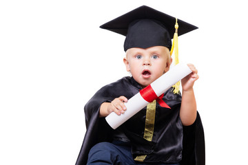 A boy in a bachelor or master suit with diploma scroll isolated on a white background. Early development, graduation, education, science, early learning baby concept