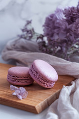 Delicious violet macarons with violet flowers