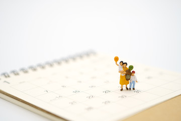 Miniature people businessmen standing on white calendar using as background business concept and finance concept with copy space  for your text or  design.