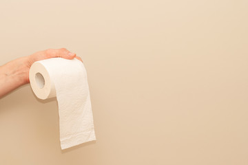 Man's hand holding and giving toilet paper roll