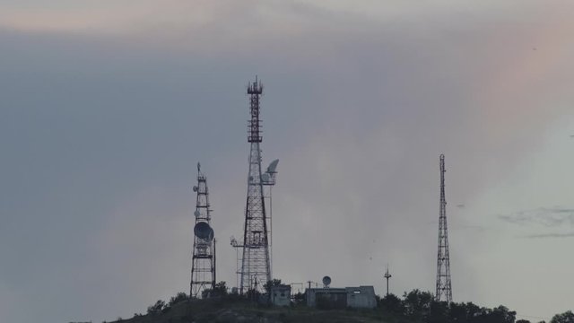 Huge TV towers on mountain at dusk