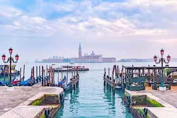 Gondolas moored by Saint Mark square with San Giorgio di Maggiore church in the background. Venice,...