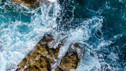 Wild Ocean water from above - Waves hitting the rocks - aerial photography