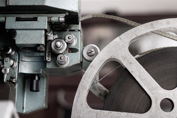 The mechanism of the old, iron film projector with a film.