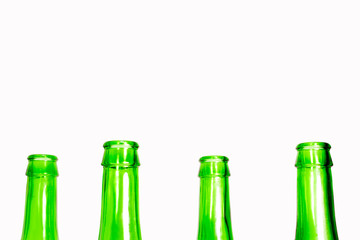 Green glass bottle nozzles on white background