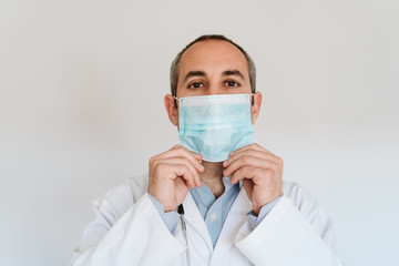 doctor man wearing protective mask and gloves indoors. Corona virus concept