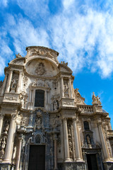 Fototapeta na wymiar The beautiful cathedral at the city of Murcia, Spain. The facade of this medieval monument. The building is elaborately decorated in the plateresque style, although the original structure is gothic.