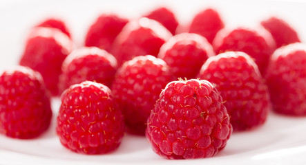 handful of raspberry berries on white background