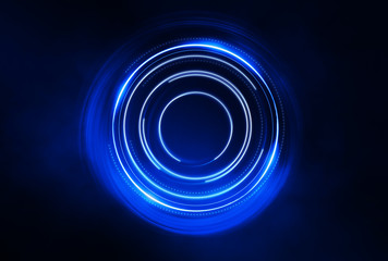 Dark abstract futuristic background. The geometric shape of the cyber circle in the middle of the scene. Neon colored rays of light on a dark background.