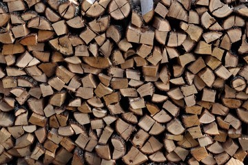 Timber - firewood is stacked at a log.