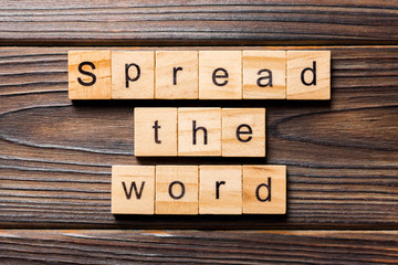 Spread the word word written on wood block. Spread the word text on table, concept