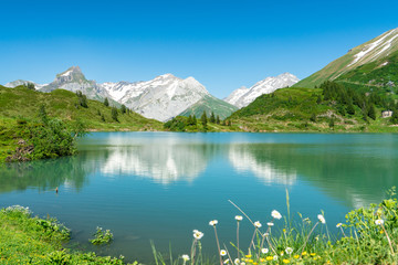 Panorama of snow mountains and lake under the blue sky; beautiful natural scenery
