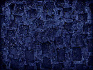 Abstract blue grunge background. Toned track texture on the ground. Abstract geometric pattern of deep traces of the tread on the surface of the soil.