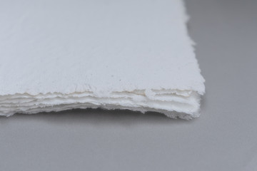 Obraz premium Handmade paper. A stack of texture paper. Concept of recycling used paper, ecology theme.
