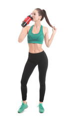 Sporty young woman with protein shake on white background